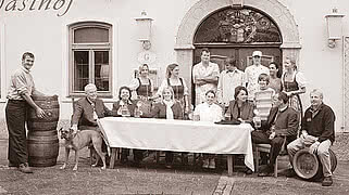 [Translate to English:] Ein altes Bild von einer Gruppe von Personen vor dem Hotel Gmachl